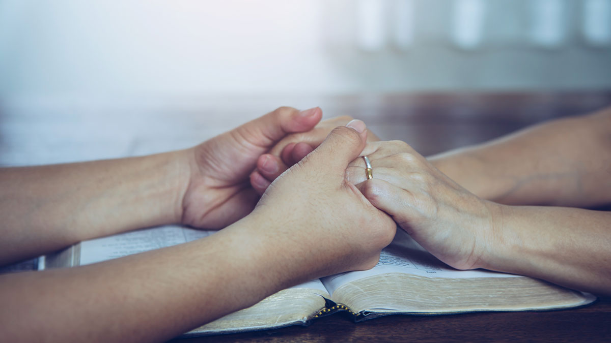 Couple hands in prayer