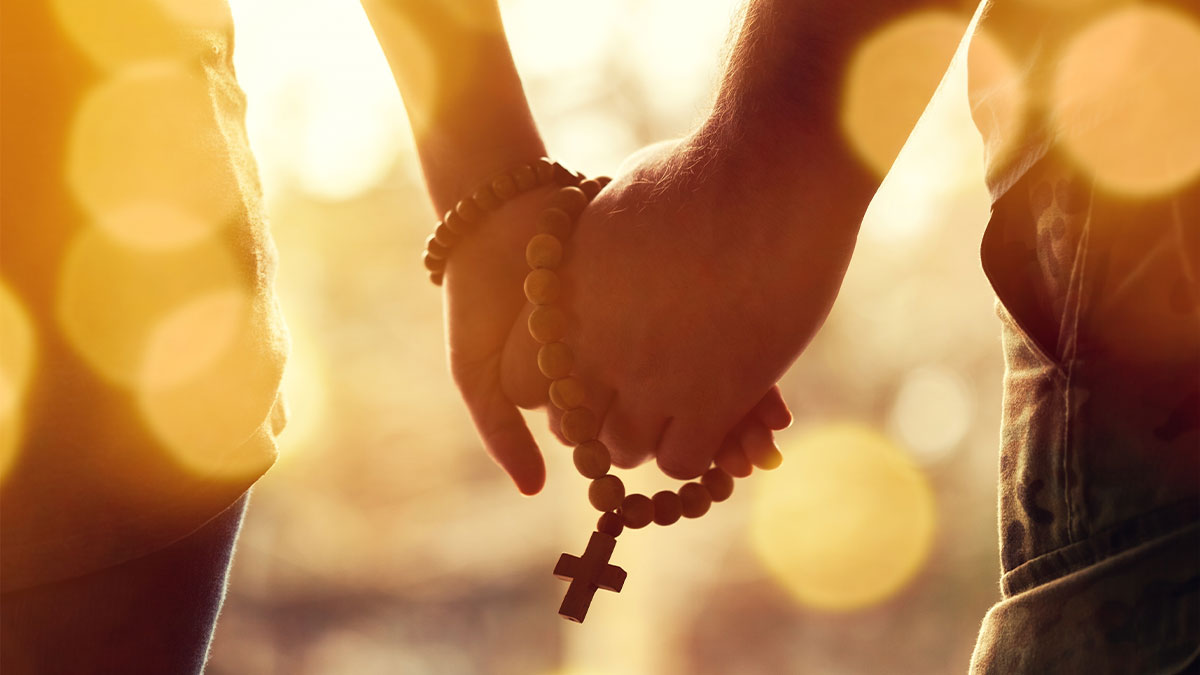 Couple Holding Hands with Rosary